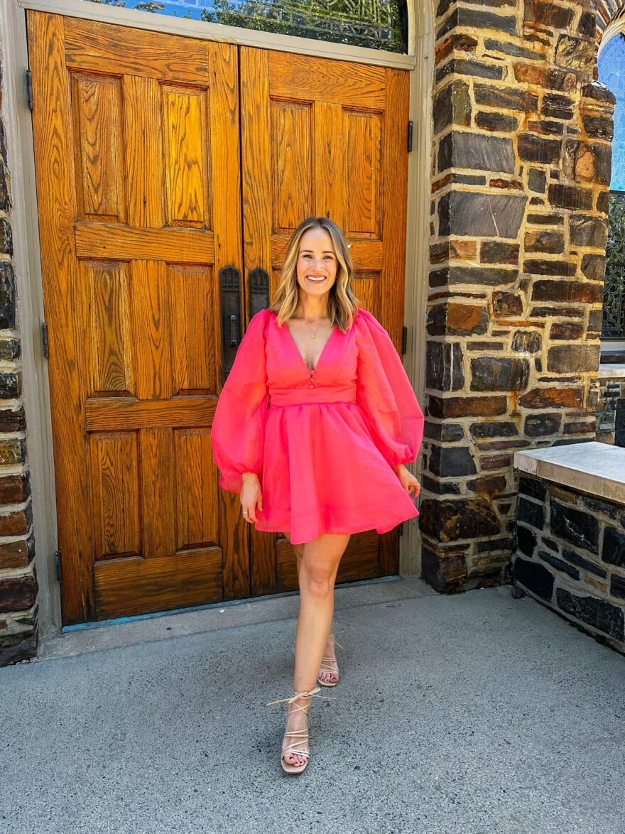 woman in pink Bardot Eva Long Sleeve Organza Minidress from Nordstrom Wedding Guest Dresses