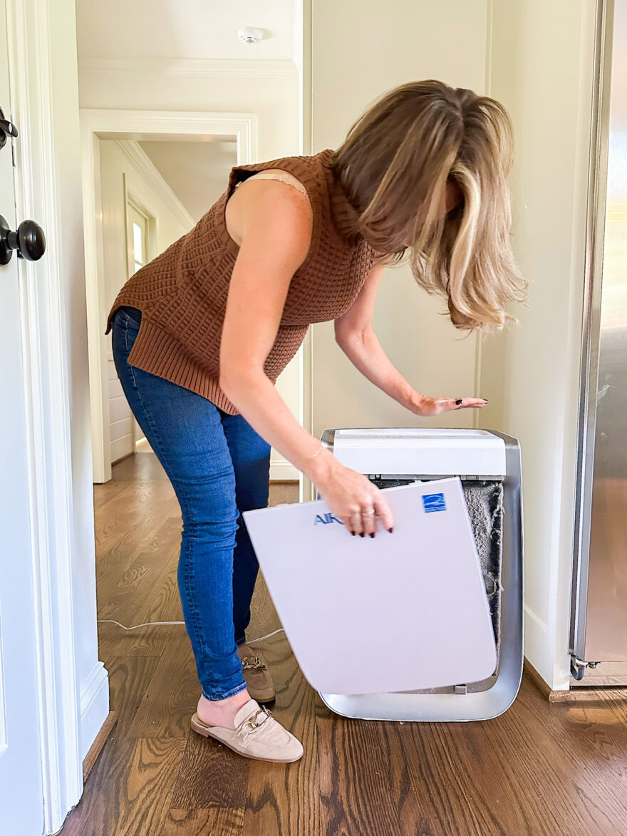TeriLyn Adams changing the filter on her air purifier 