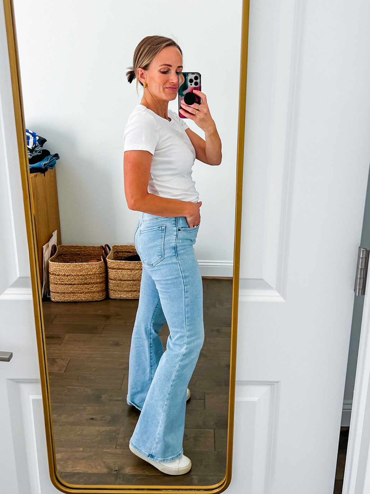 TeriLyn Adams showing the side details of her Ultra High Rise Flare Jean