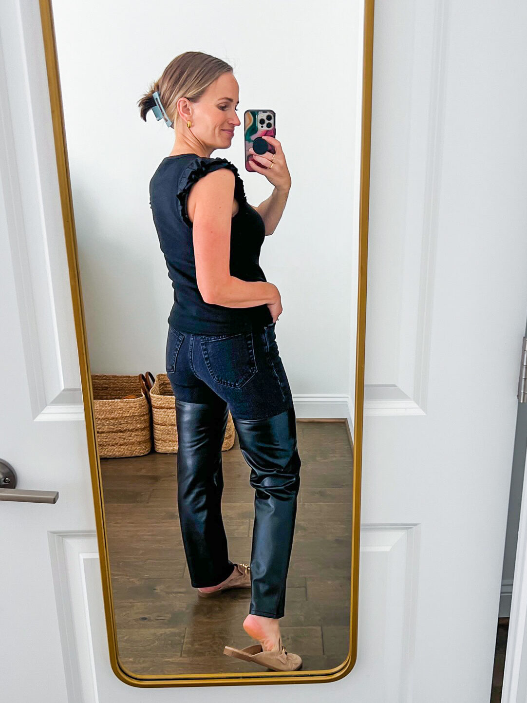 TeriLyn Adams showing the back details of the the Ultra High Rise 90s Straight in leather and denim pants