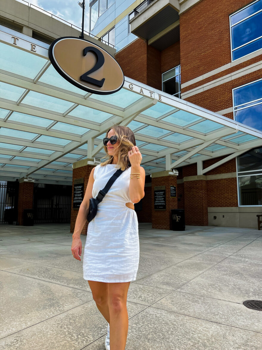 TeriLyn Adams wearing white cutout dress one of the outfits for what to wear to a football game