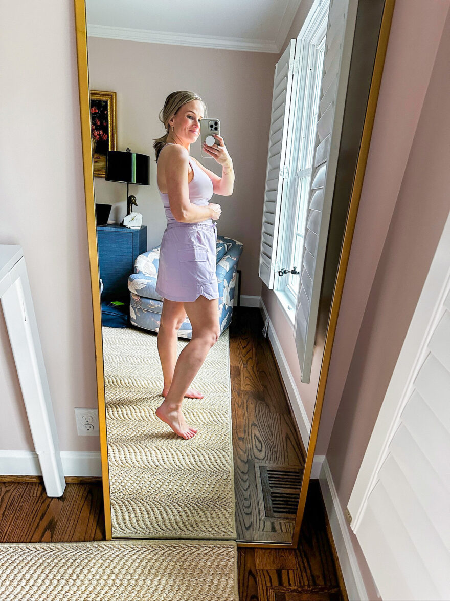 TeriLyn Adams wearing the Anywhere Built-In Bra Tank with the lightweight One Cargo Skirt in lavender from Fabletics