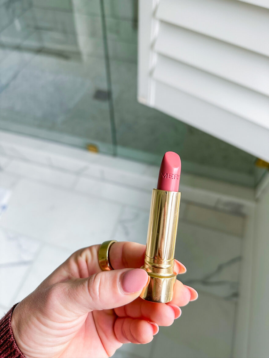 TeriLyn Adams holding Signature Lip Lightweight Lipstick