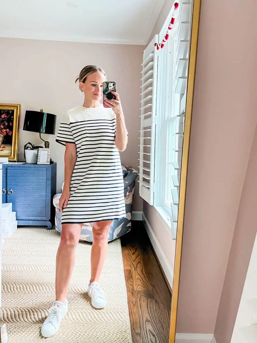 Woman modeling Tuckernuck's Navy Knit Striped Frenchie Dress with white tennis shoes
